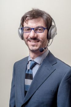 businessman with headphone and microphone on gray background