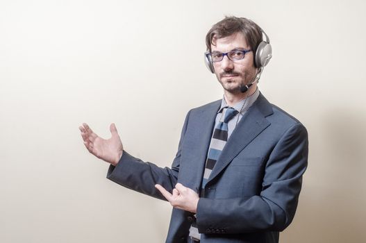 businessman with headphone and microphone on gray background