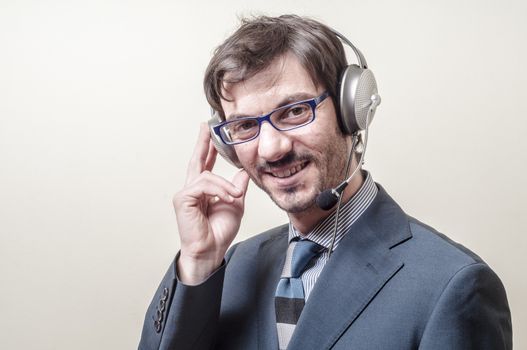 businessman with headphone and microphone on gray background