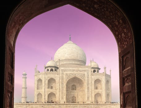 Taj Mahal through arch, Indian Symbol - India travel background. Agra, Uttar Pradesh, India