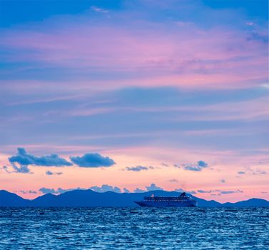 Vacation cruise background - sunset sea with cruise ship. Andaman sea, Thailand