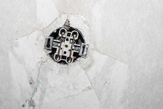 grungy white background of natural cement with open electric socket