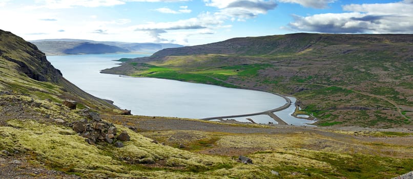 Iceland summer landscape. Fjord, house, mountains. Panorama.