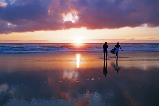 Surferrs at the ocean at sunset in Portugal