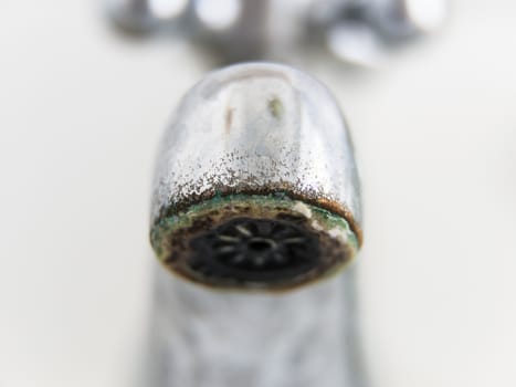 Old and grungy tap closeup, white background