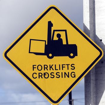 Forklift Crossing - yellow road sign on the pole