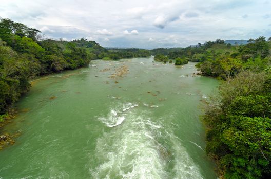 Wide green river running through the wilderness of Chiapas, Mexico