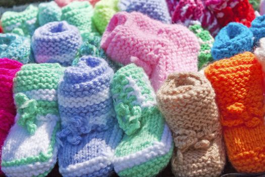 A miniature knitted shoes for kids on the counter