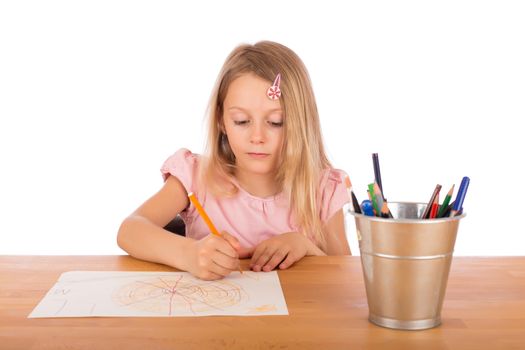 Child draw a pretty picture on a wooden table. Isolated on a white background.