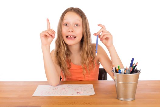 Child sitting at a table found an idea to draw. Isolated on a white background.