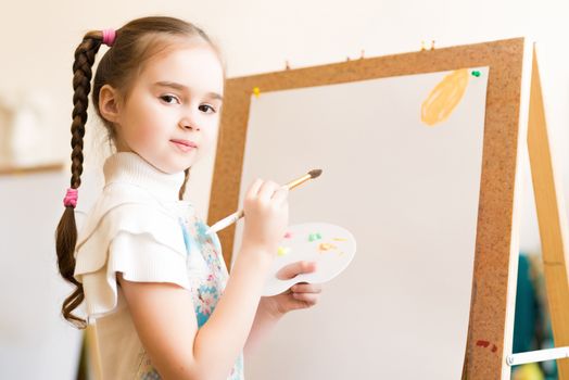 portrait of a girl standing next to his easel, a drawing lesson