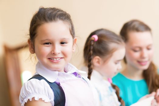 Portrait of Asian girl in apron interested in painting at an art school