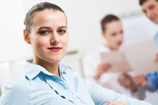 portrait of a business woman in office, smiling and looking into the camera, office work