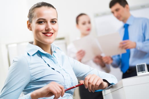 portrait of a business woman in office, smiling and looking into the camera, office work