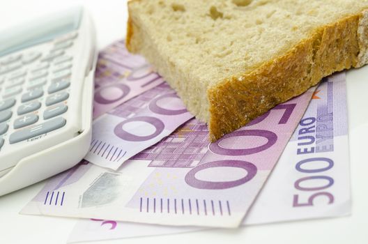 Piece of bread on Euro money. Food budget.