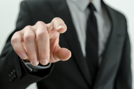 Closeup of businessman hand touching virtual screen.