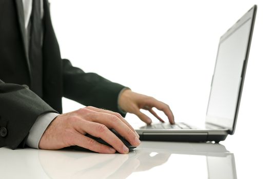 Close up of business man working on laptop. Isolated over white background.