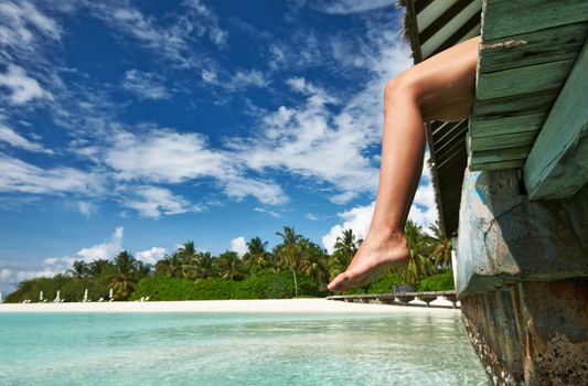 Woman's legs at beach jetty
