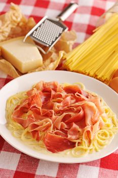 Pasta carbonara over red cloth