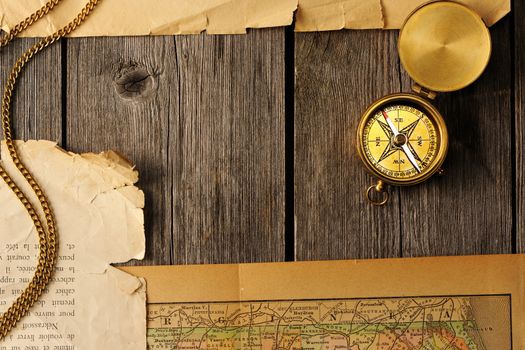 Antique brass compass over old map