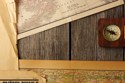 Antique wooden compass over old map