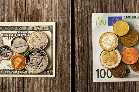 US and euro currency over wooden background