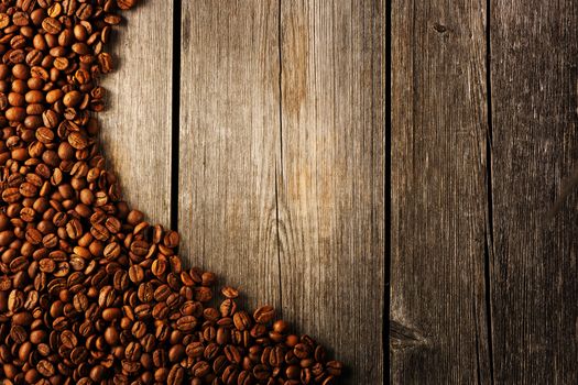 Coffee beans over wooden background