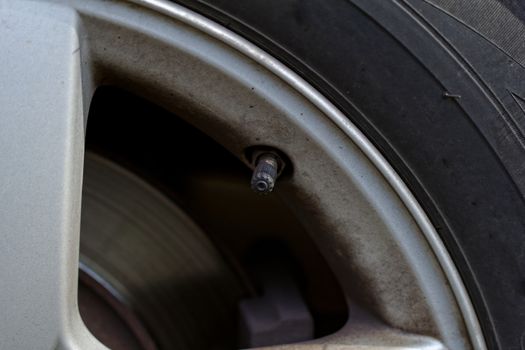 close up tire valve on the rim of a luxury sports car 
