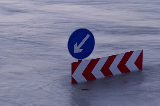 Direction indicator boards on the flooding river