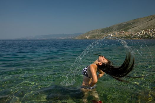 Woman splashing water in the sea