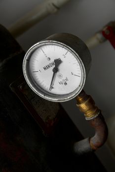 Old, rusty manometer on a gas tank