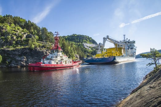 Tug Achilles and tug Belos have started towing the MV North Sea Giant through Ringdalsfjord in Halden, Norway.