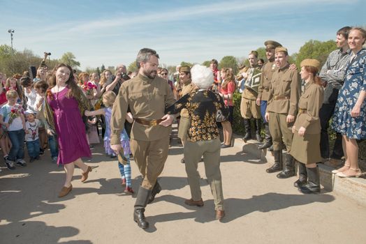 Moscow, Russia - May 9, 2013: Group of young peoples in uniform decorated dancing during with veterans festivities devoted to 68th anniversary of Victory Day.