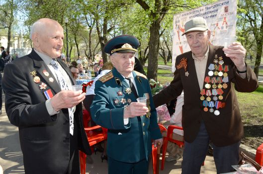 Moscow, Russia - May 9, 2013: Three old man veteran of WWII in uniform decorated with numerous orders and medals   during festivities devoted to 68th anniversary of Victory Day.