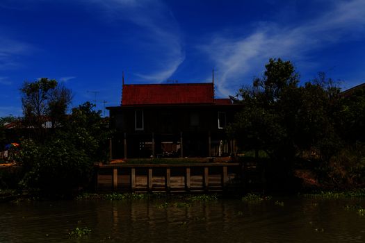 Thai traditional house along the river, Living with natural take photo from river.
