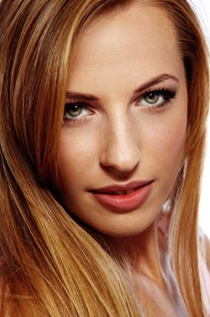 Close-up portrait of the smiling lady looking to the camera