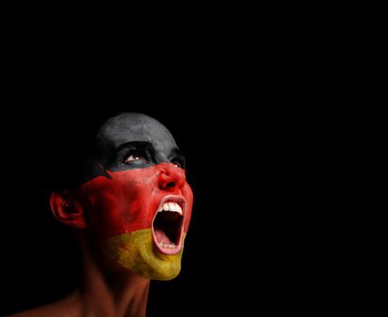 The German flag on the face of a screaming woman. concept