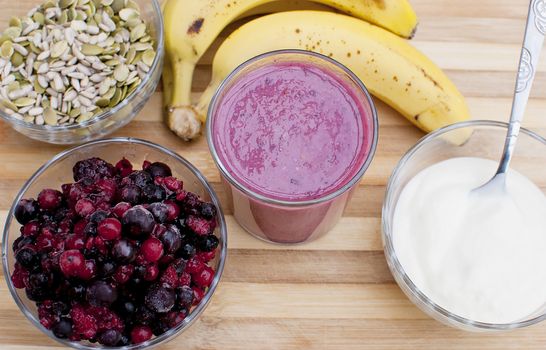 healthy berries juice smootie on wooden board