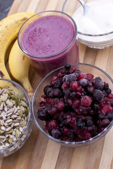 healthy berries juice smootie on wooden board