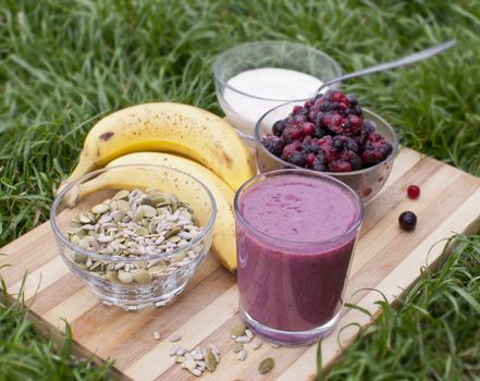 healthy berries juice smootie on wooden board