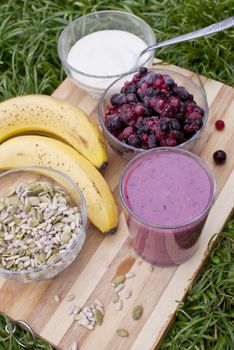 healthy berries juice smootie on wooden board