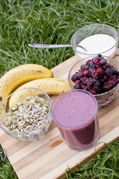 healthy berries juice smootie on wooden board