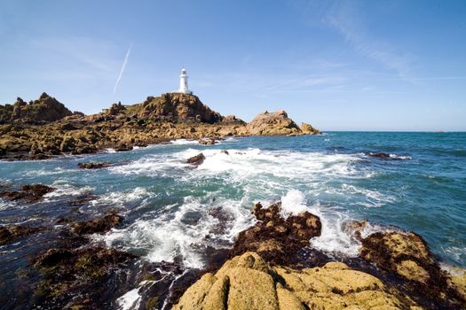 Corbiere Lighthouse and the rocky coast in Jersey, The Channel Islands