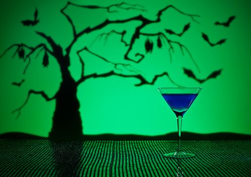 Cobalt Martini in Halloween setting with bats and a tree