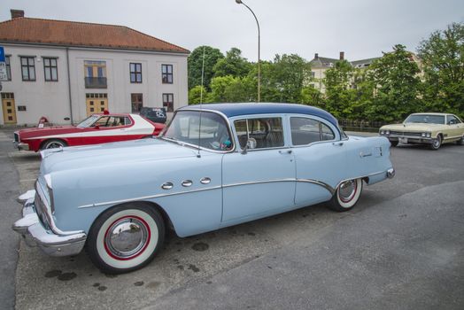 The image is shot at a fish-market in Halden, Norway where there every Wednesday during the summer months are held classic American car show.