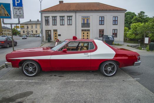 The image is shot at a fish-market in Halden, Norway where there every Wednesday during the summer months are held classic American car show.