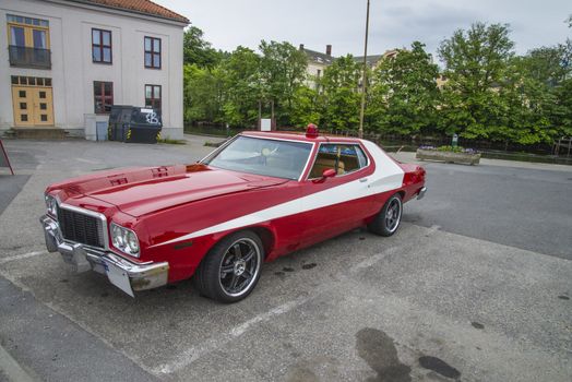 The image is shot at a fish-market in Halden, Norway where there every Wednesday during the summer months are held classic American car show.