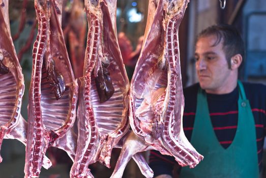 PALERMO - DECEMBER 29: butcher sells meat on the local market in Palermo, called Ballaro. This market is also tourist attraction in Palermo, Sicily, Italy on Dec. 29, 2012.