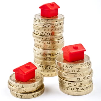 �1 Coins Stacked up in three piles.  Saving for a Home.