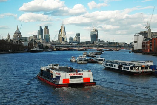 Floating boats on Thames, view from the bridge